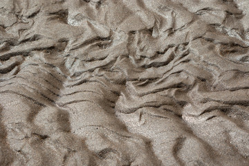 Sand rippled textured pattern created by low tide. Abstract background