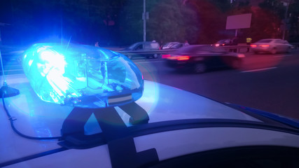 Closeup blinking strobe lights on police car, blue lightbar, emergency situation © motortion