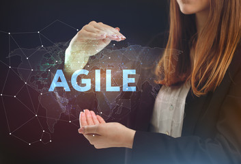 The concept of business, technology, the Internet and the network. A young entrepreneur working on a virtual screen of the future and sees the inscription: Agile