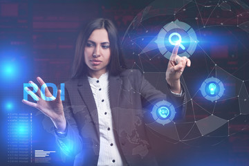 The concept of business, technology, the Internet and the network. A young entrepreneur working on a virtual screen of the future and sees the inscription: ROI