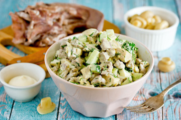 Pork tongue, mushrooms, fresh cucumber salad on kitchen table with ingredients. Russian cuisine