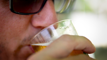 young men drinking beer in bar, closeup cinematic dof shot