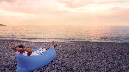Fototapeta na wymiar Free man relaxing on beach, enjoying seascape view, having rest on vacation