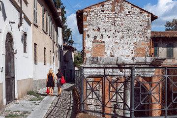 Fototapeta na wymiar A small street of Brescia with the Roman historical ruins (Brescia, Lombardy, Italy)