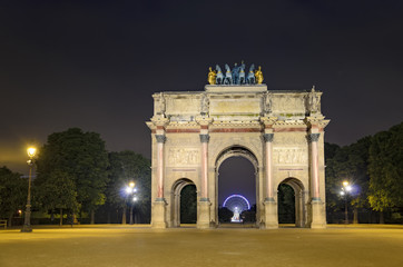 Arc de Triomphe at the Place du Carrousel in Paris in the night with Ferris wheel at Concorde at...