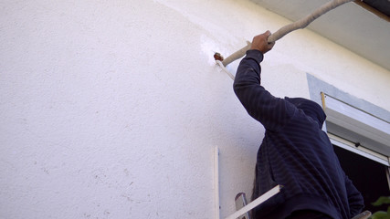 Male technician repairing, installing outdoor air conditioner unit