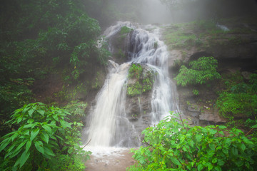 A scenic waterfall in the forest, a rainy foggy/misty waterfall landscape in India.