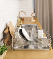 Kitchen with various kitchen tools, background with kitchen racks and plants. The appearance of drying dishes and bowls.