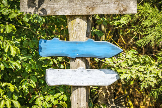 Wooden arrow sign with arrows in colors