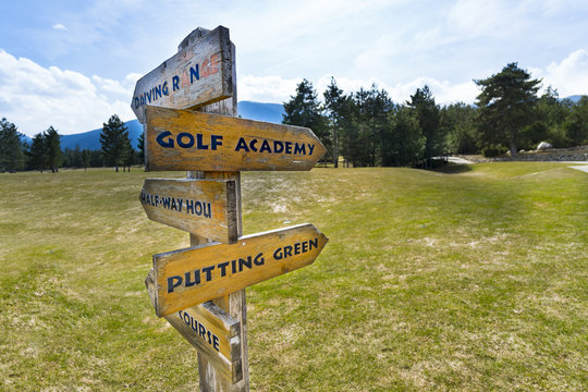 Concept image of a signpost with golf course information on the arrows