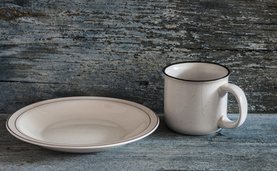 White plates with cup on a blue wood background