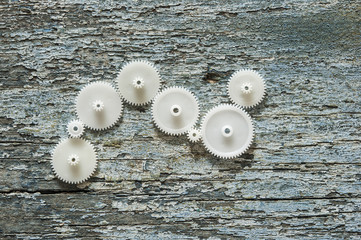 Gear wheels on a wooden background. The concept of creative, logical thinking. Logic background.