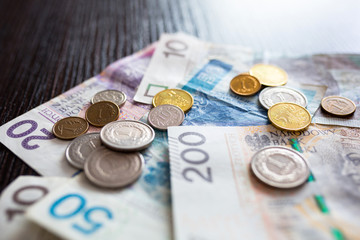Stack of polish zloty banknotes and coins