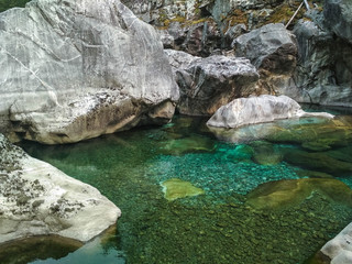 Naklejka na ściany i meble journey mountain blue lake, a river among rocks and rocks.