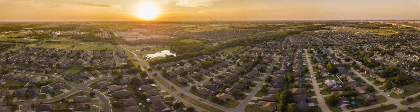 Aerial panorama of planned development and neighborhoods in Oklahoma City at sunset.