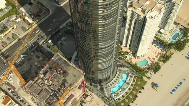 Amazing aerial Porsche Design Tower rooftop tilt up