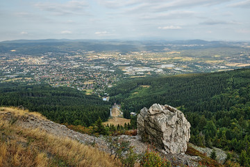 Obraz premium Czech landscape with big stone above Liberec city viewed from Jested hill at summer evening sunset 50 years after soviet occupation of Czechoslovakia 1968