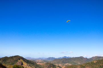 Paraglider flying from top of the world mountain Mountain landscape  Brazil