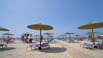 beach umbrellas and sunbeds on summer vacation resort