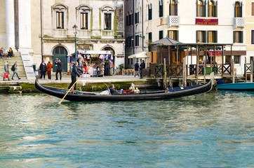 Venice, Italy - circa Mar, 2016: Beautiful scene with traditional gondola and canal in Venice, Italy