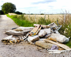 Heap of illegally dumped household rubbish left in a little used country lane. Environmental hazard, with furniture. mattresses and carpets. Fly tipped detritus. Oxfordshire. - 220286919