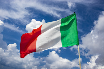 Italian flag waving in the blue sky