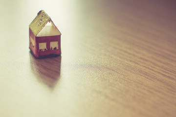 small toy rural house on a wooden table