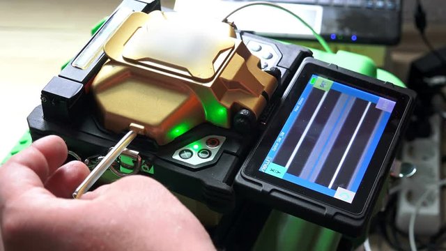  Fiber Splicing Tool Machine in use for connecting fiber optic cable