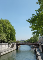 Seine river in Paris with bridge Pont de l’Archeveche near Notre Dame church