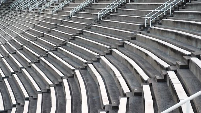 Pan and Tilt Down of Empty Stadium Bleachers. 4K