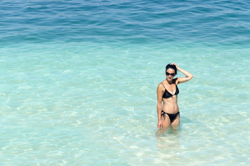 Portrait of sexy young woman wearing a bikini on the tropical beach