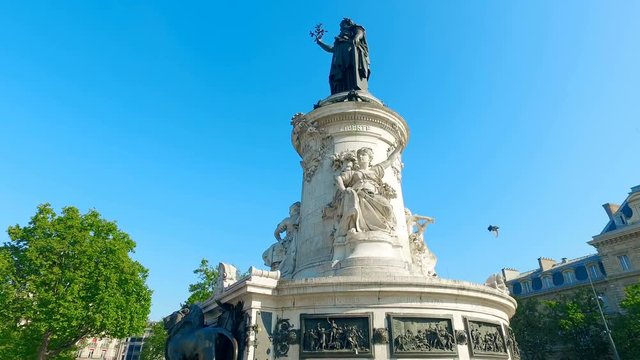 Paris. The Place de la Republique. Bronze statue of Marianne holding an olive branch, steadicam cinematic shot