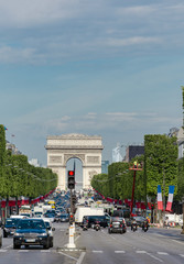 Paris, France - circa May, 2017: Traffic jam during rush hour on Champs Elysees avenue in Paris with view of Arc de Triumph at background. It is the most popular shoping street in Paris