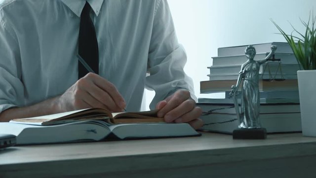 Lawyer working in office, reading legal books and searching for information