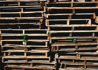 Stacked wooden pallets. Faded grunge look.