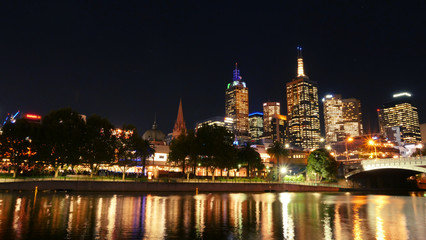 Fototapeta na wymiar Australia, Victoria, Melbourne downtown and Yarra river at night time. Space for text