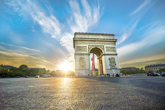 Paris Arc de Triomphe (Triumphal Arch) in Chaps Elysees at sunset, Paris, France. Architecture and landmarks of Paris. Postcard of Paris