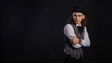 Fototapeta premium The handsome caucasian young man in a white shirt, suit and hat