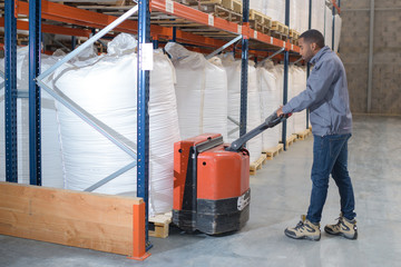man on forklift loading boxes at warehouse