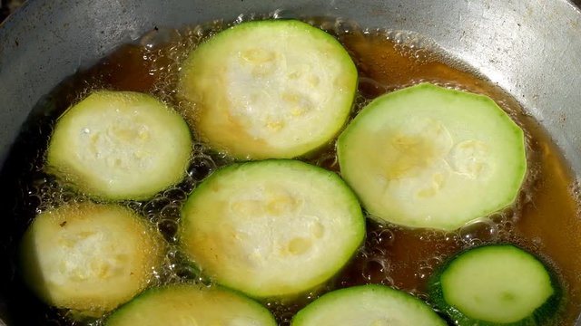 Fried zucchini in a frying pan