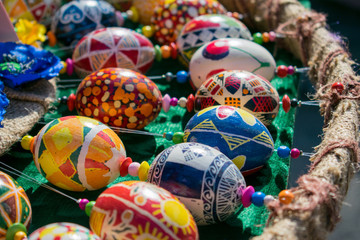 Colorful hand painted easter eggs with a variety of patterns. Bright close-up of handmade rustic painted Easter eggs background