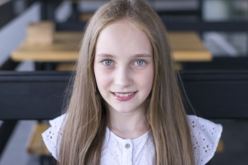 Charming blond model sitting alone at cafe