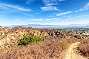 Mountain hiking trails above Southern California suburbs in the inland area on hot summer day