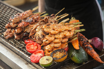 Fresh grilled shrimp and octopus kebabs with lemon and avocado