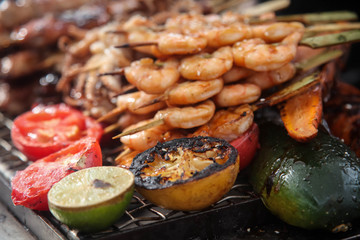 Fresh grilled shrimp and octopus kebabs with lemon and avocado