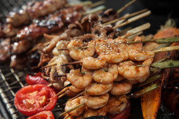 Fresh grilled shrimp and octopus kebabs with lemon and avocado