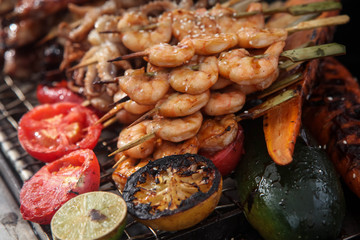 Fresh grilled shrimp and octopus kebabs with lemon and avocado