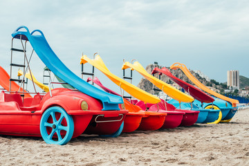 colorful Pedalos on the beach sand