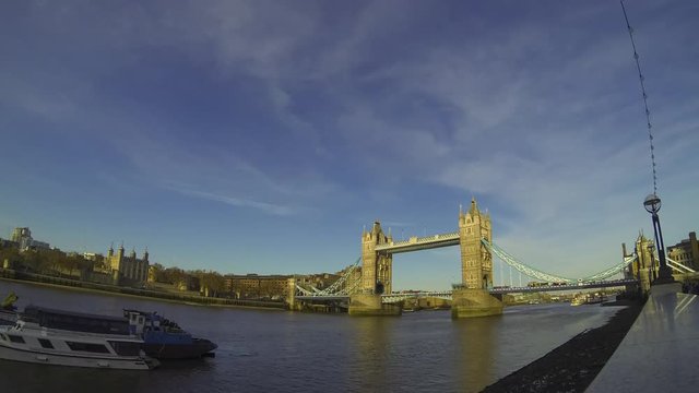 Time lapse footage at afternoon with the famous Tower Bridge from South Bank in London, UK. A lot of tourists taking pictures. Ultra wide angle lens.