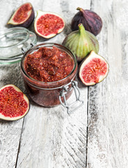 Figs marmalade in jar Fruit jam rustic wooden background